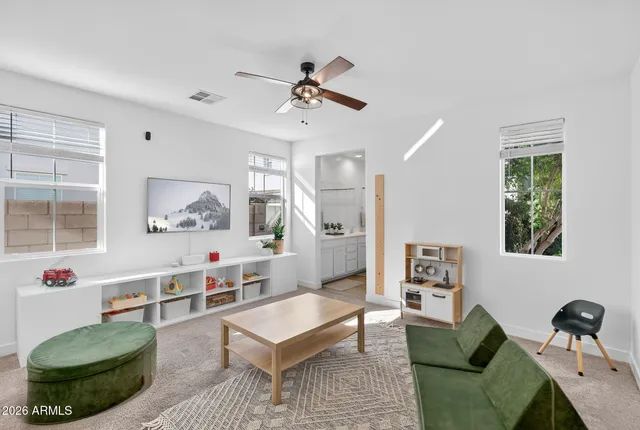 a kitchen with stainless steel appliances kitchen island a refrigerator and a table