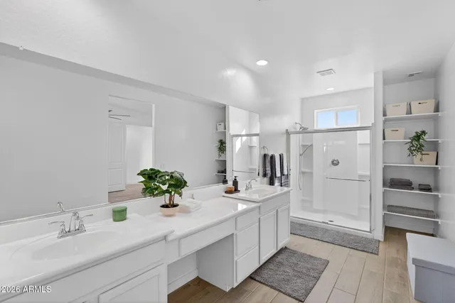 a bedroom with a bed and a ceiling fan