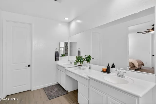 a bathroom with a double vanity sink a mirror and a shower