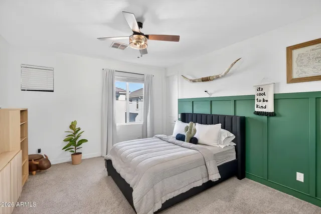 a bedroom with a bed couch and a window