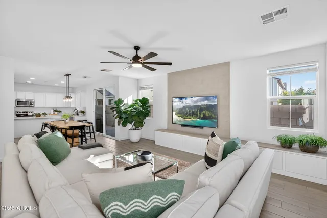 a living room with furniture potted plant and a table