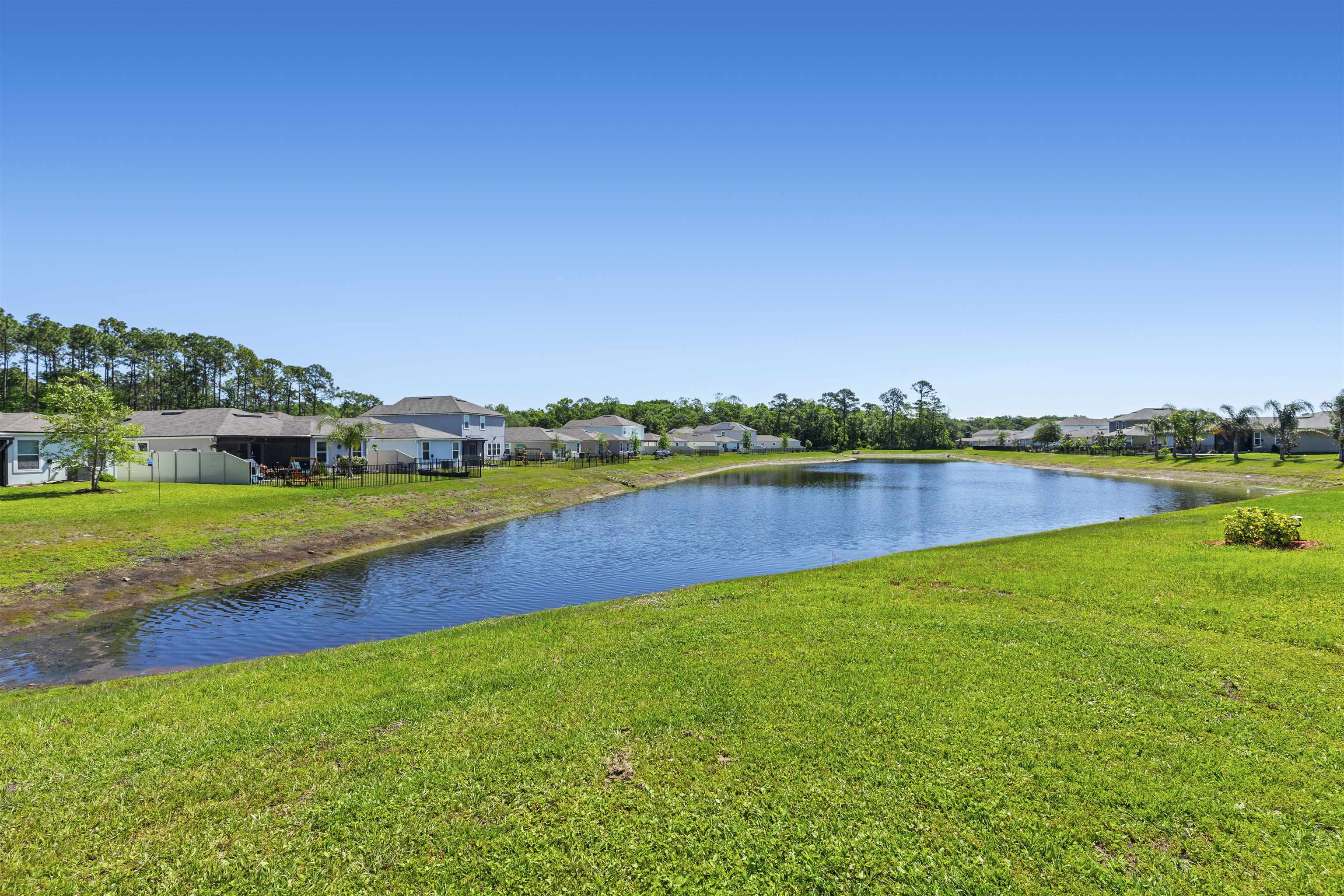266 Caminha Road St. Augustine, FL 32084 - Photo 45 of 59 a view of a lake with houses in the back