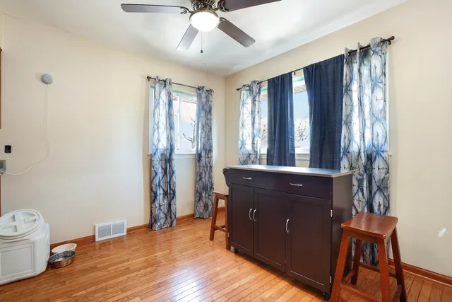 a view of a bedroom with a window and wooden floor