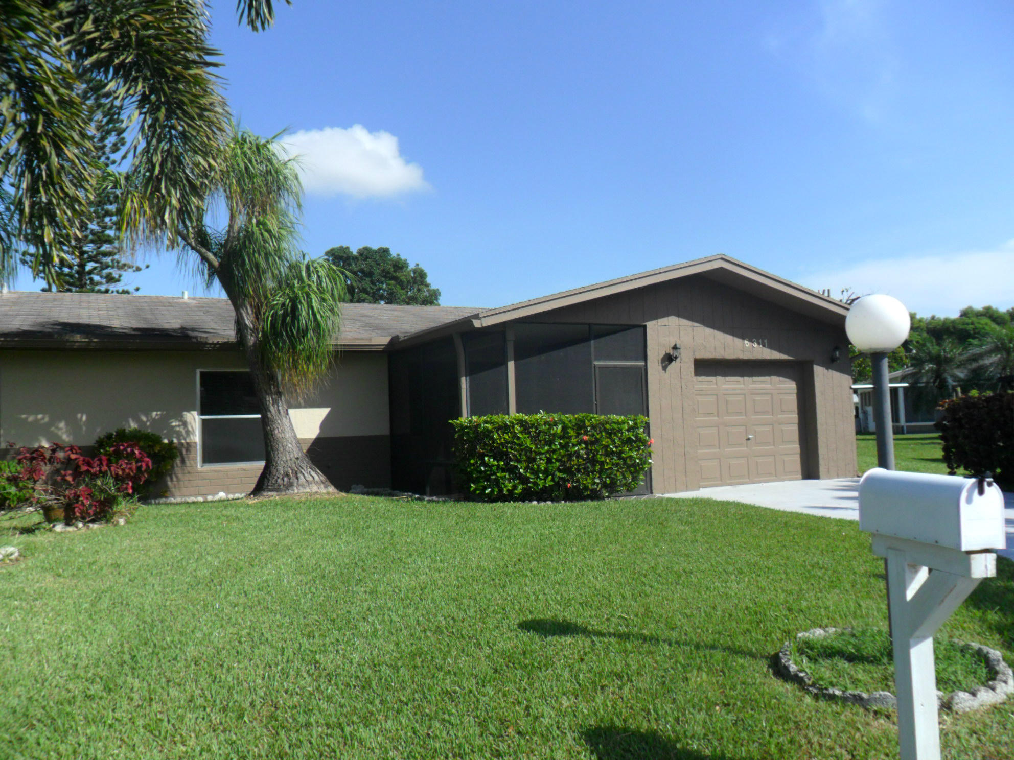 6311 Lasalle Road Delray Beach, FL 33484 - Photo 2 of 34 a front view of house with yard and green space