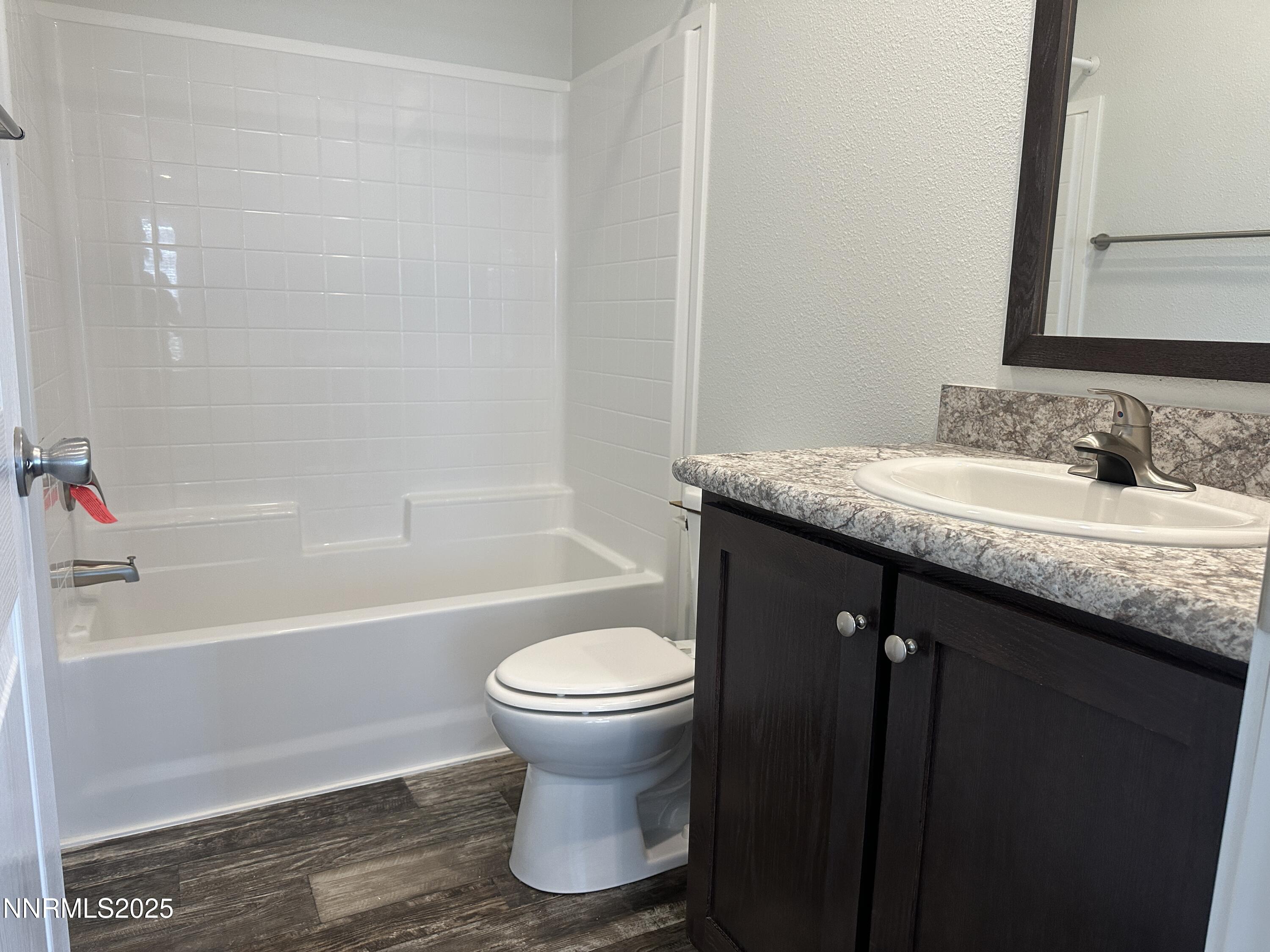 7650 Sylvia Ridge Winnemucca, NV 89445 - Photo 12 of 16 a bathroom with a granite countertop sink toilet and shower