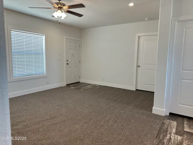 a view of a livingroom with a ceiling fan and window