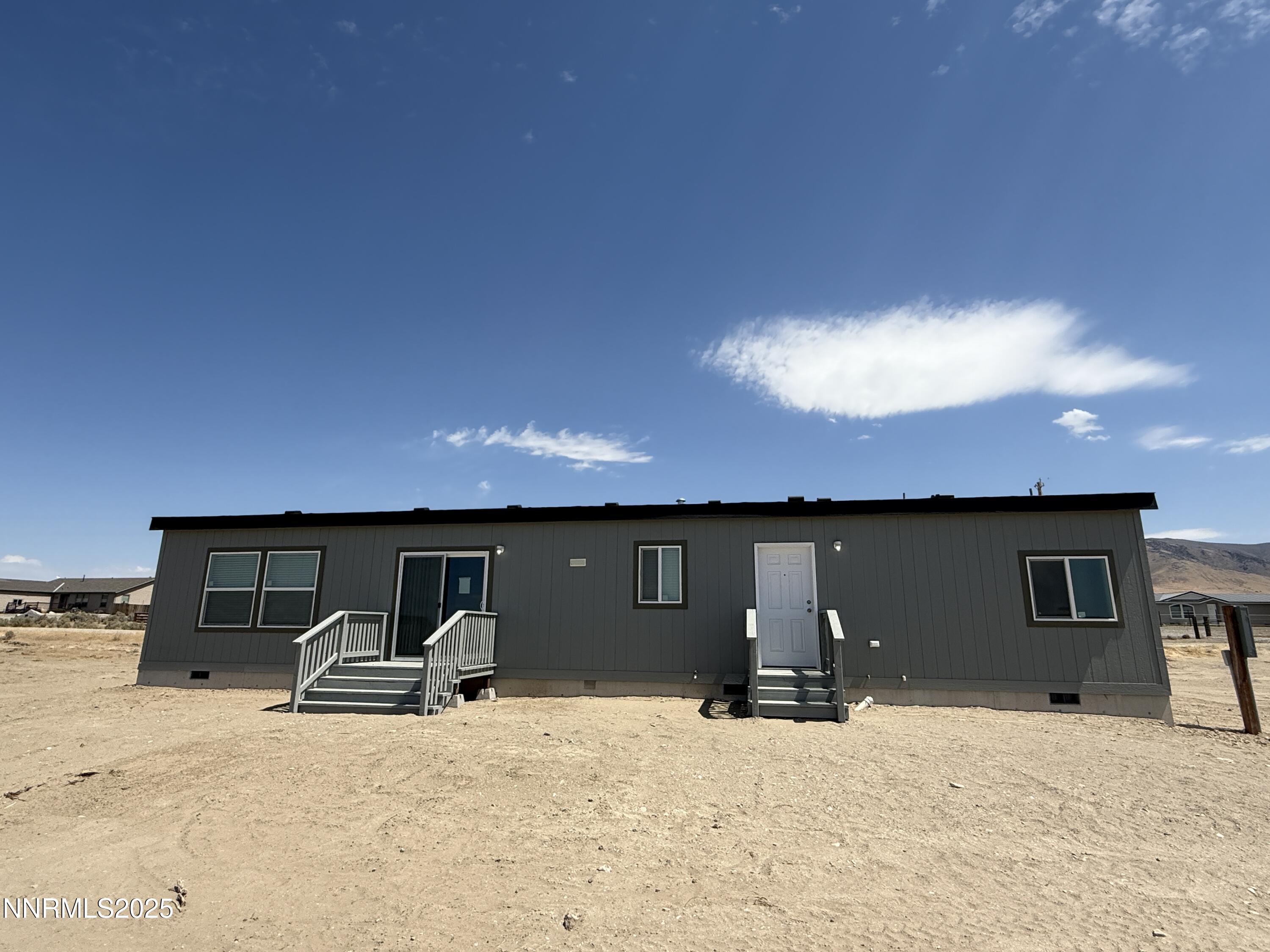 7650 Sylvia Ridge Winnemucca, NV 89445 - Photo 16 of 16 a view of a house with a barbeque and roof