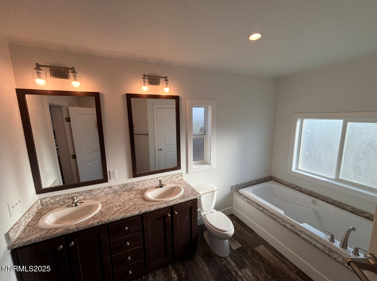 7650 Sylvia Ridge Winnemucca, NV 89445 - Photo 7 of 16 a bathroom with a granite countertop toilet sink and mirror