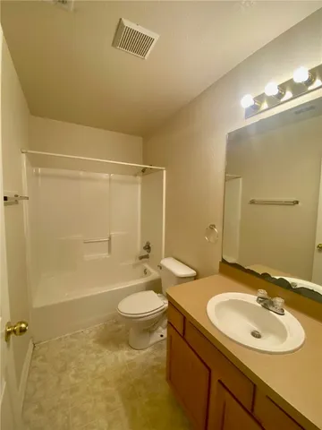 a bathroom with a sink mirror toilet and bathtub