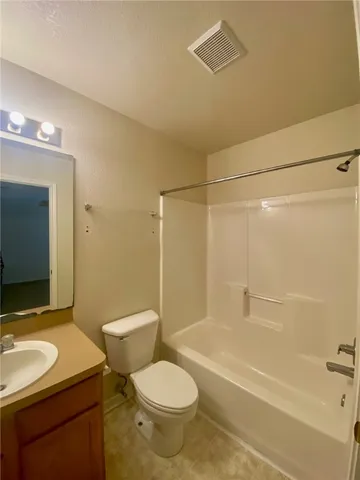 a bathroom with a sink toilet vanity and shower