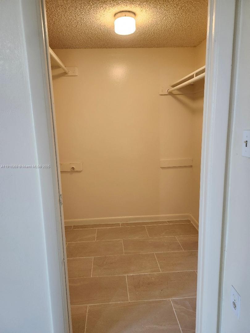 8520 Southwest 133rd Avenue Road, Unit 415 Miami, FL 33183 - Photo 6 of 12 a bathroom with a glass shower door