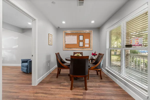 a room with a bed window and a flat screen tv