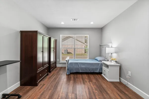 a living room with furniture wooden floor and kitchen view