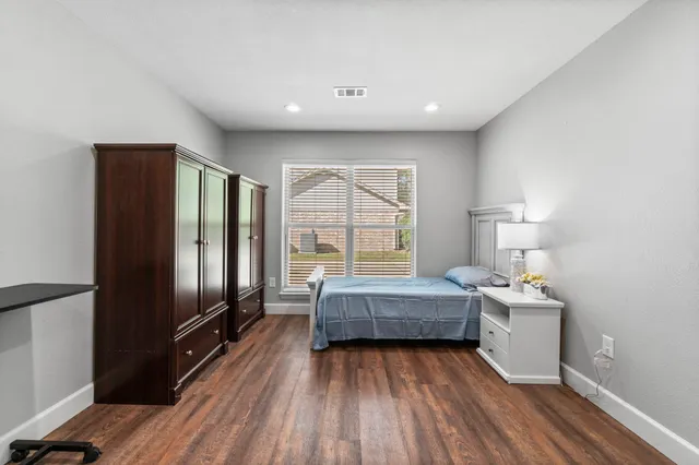 a living room with furniture wooden floor and kitchen view