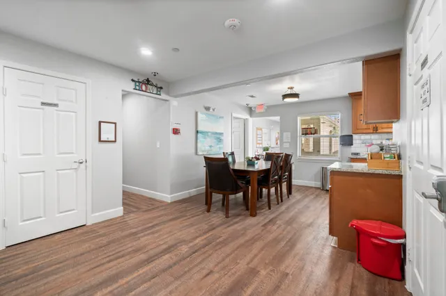 a view of kitchen with refrigerator dining table and chairs