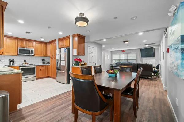a kitchen with stainless steel appliances granite countertop a stove sink and cabinets