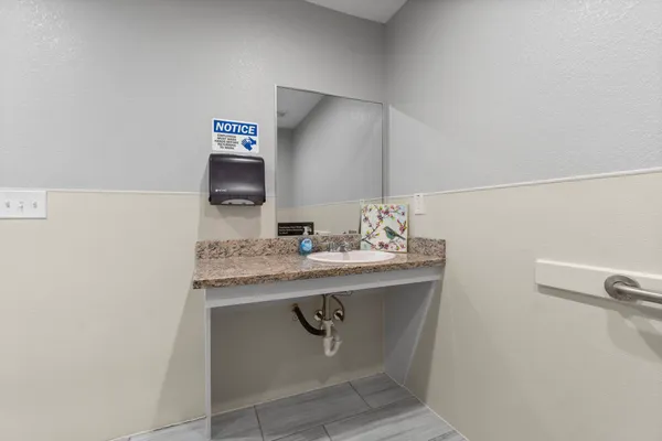 a living room with furniture a mirror and a flat screen tv