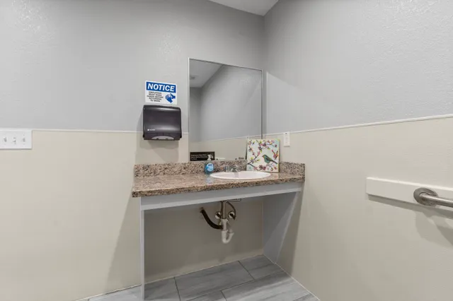 a living room with furniture a mirror and a flat screen tv