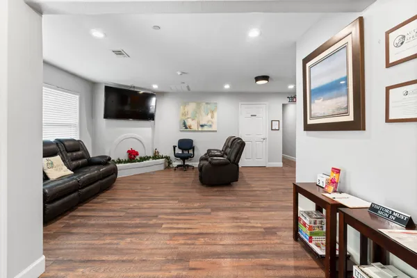 a living room with furniture and a fireplace