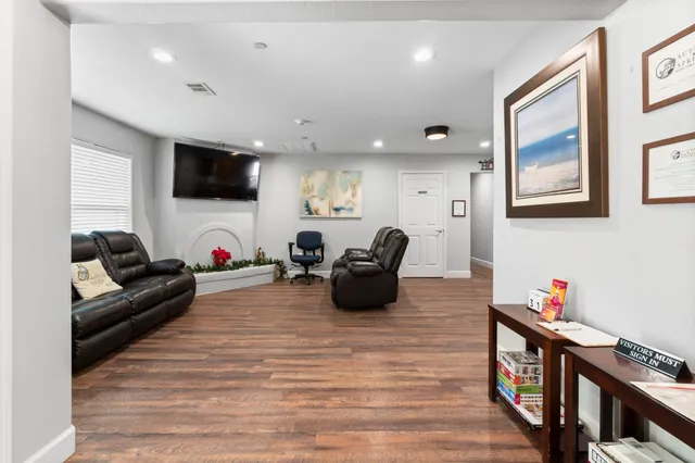 a living room with furniture and a fireplace
