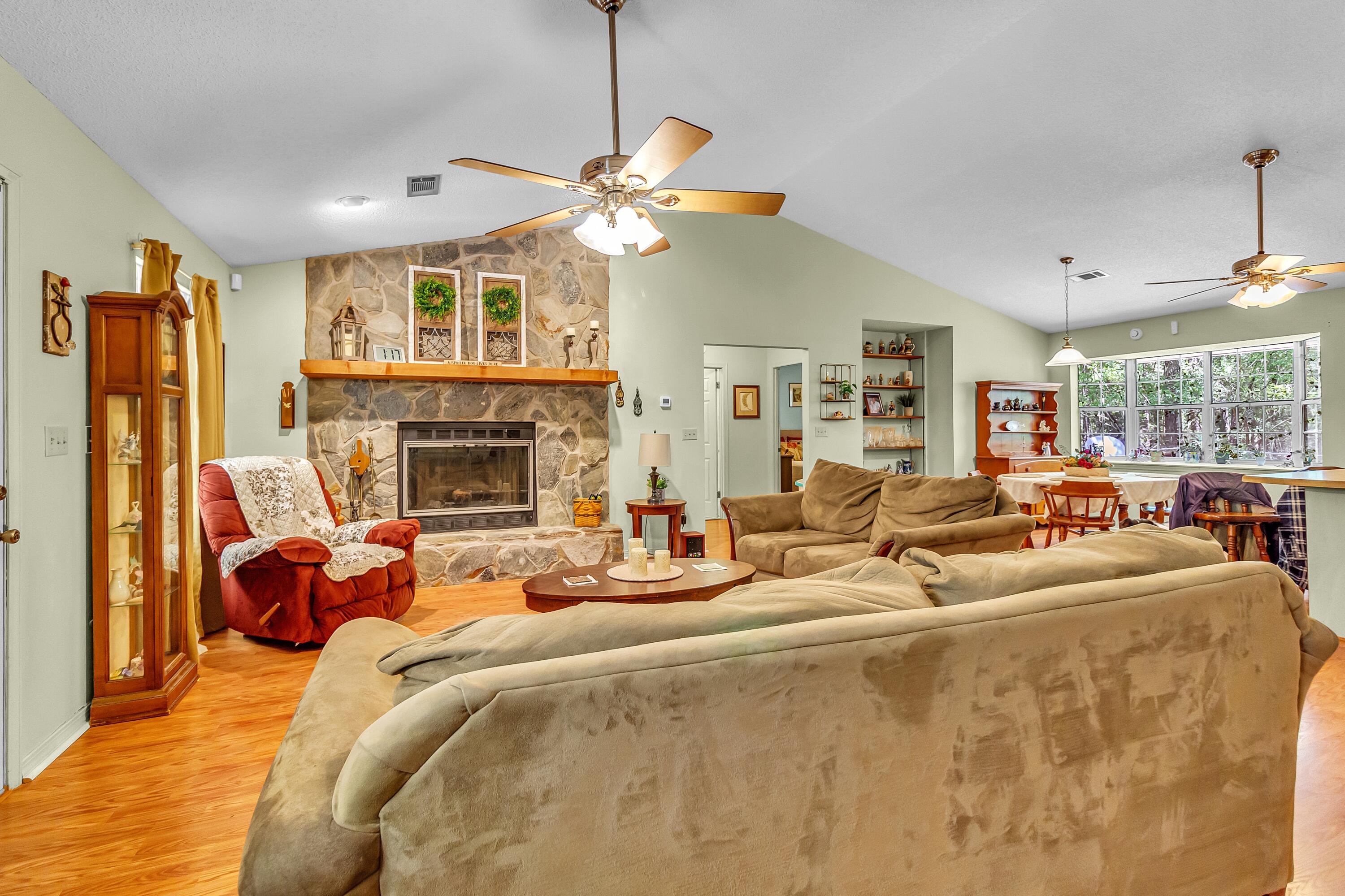 5957 Ridgecrest Road Crestview, FL 32539 - Photo 11 of 56 a living room with fireplace furniture and a chandelier