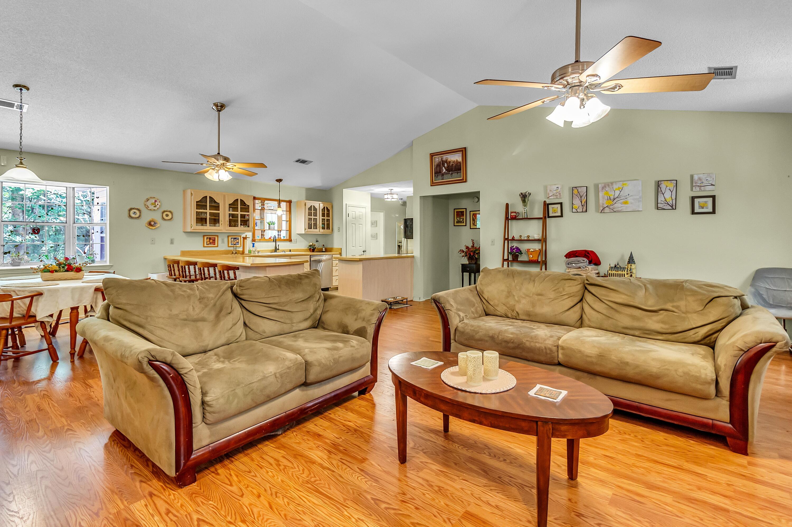 5957 Ridgecrest Road Crestview, FL 32539 - Photo 12 of 56 a living room with furniture and a chandelier