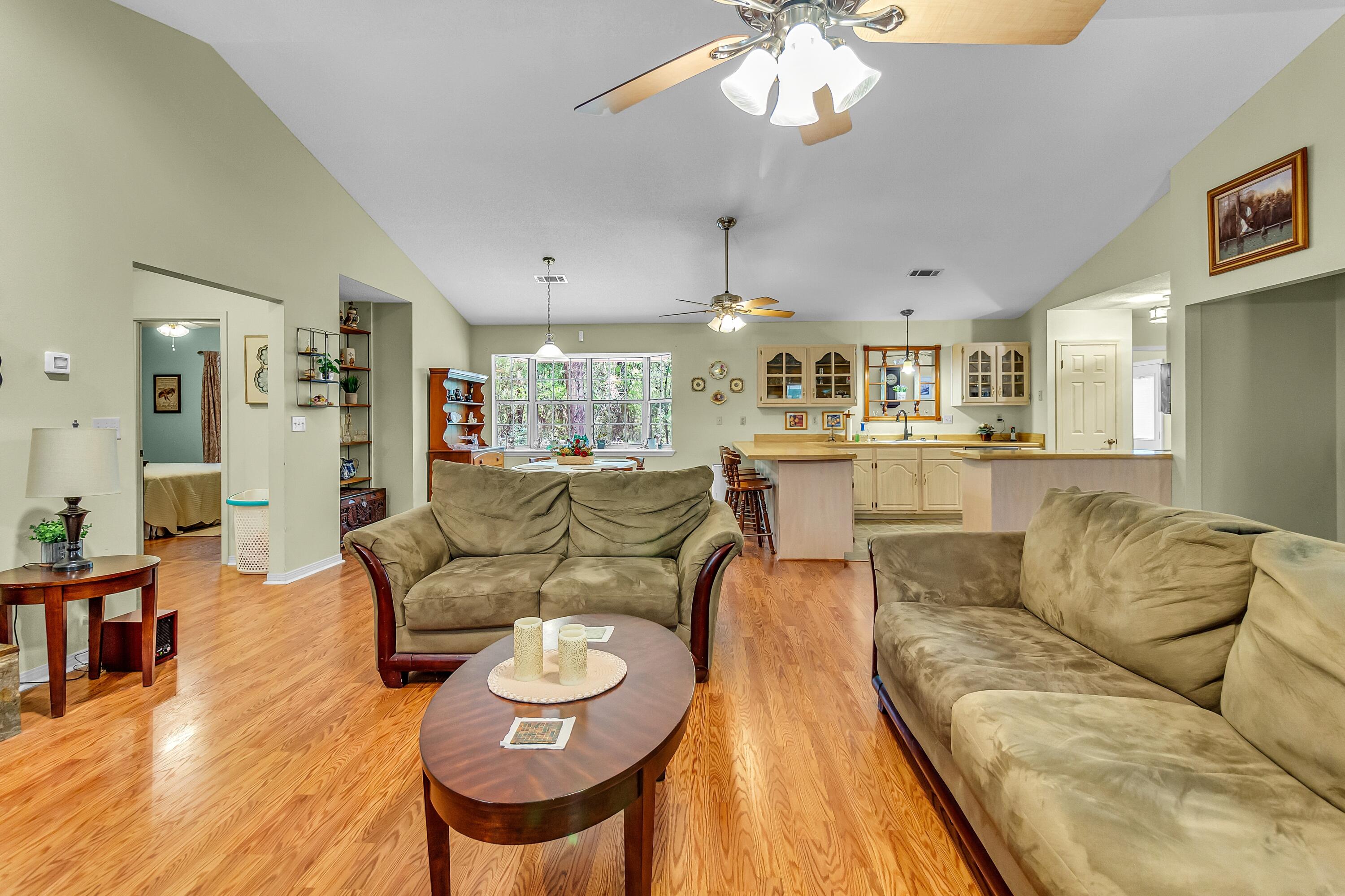 5957 Ridgecrest Road Crestview, FL 32539 - Photo 13 of 56 a living room with furniture and a chandelier