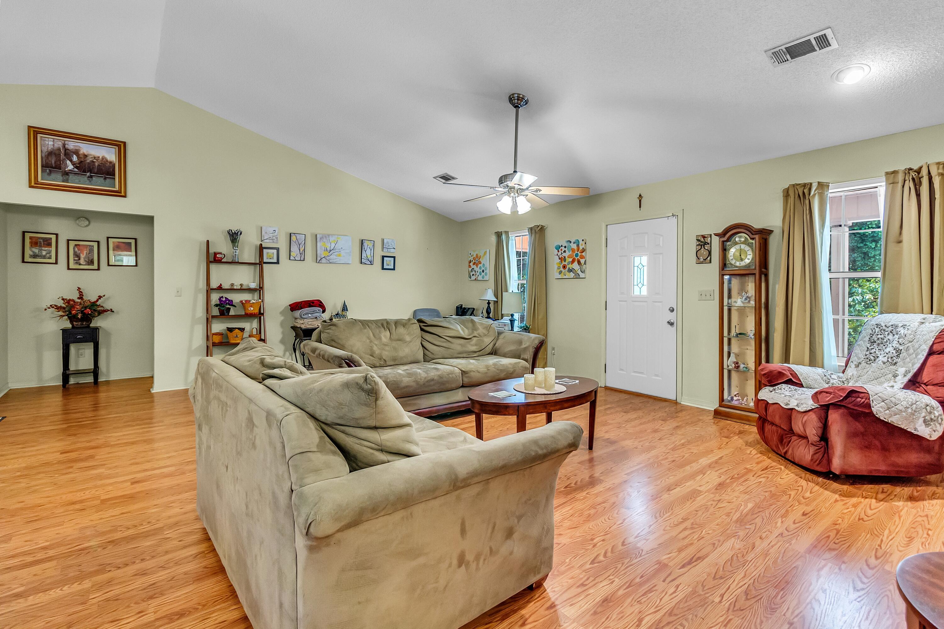 5957 Ridgecrest Road Crestview, FL 32539 - Photo 14 of 56 a living room with furniture and a chandelier