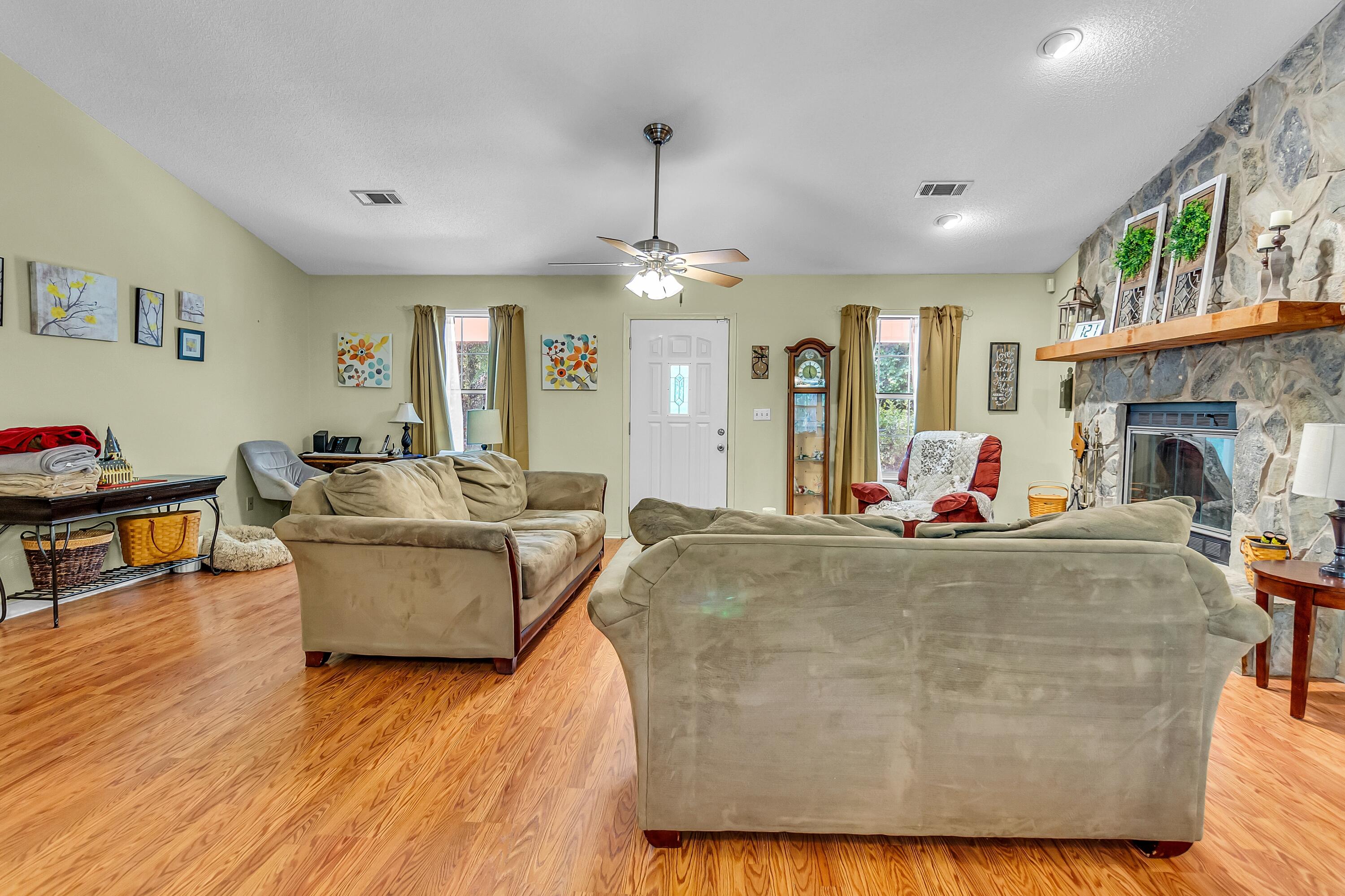 5957 Ridgecrest Road Crestview, FL 32539 - Photo 16 of 56 a living room with fireplace furniture and a chandelier