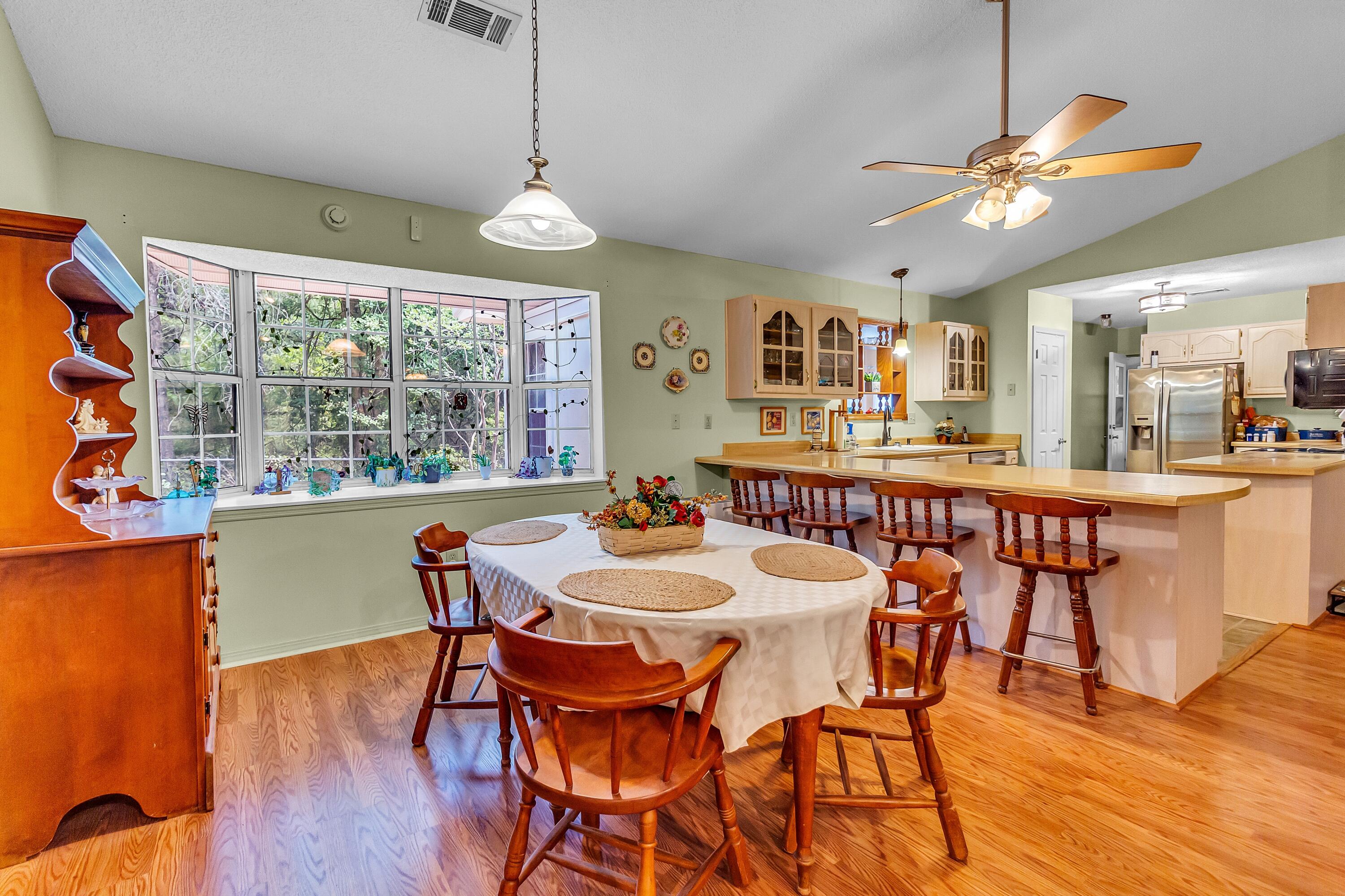 5957 Ridgecrest Road Crestview, FL 32539 - Photo 17 of 56 a view of a dining room with furniture window and wooden floor