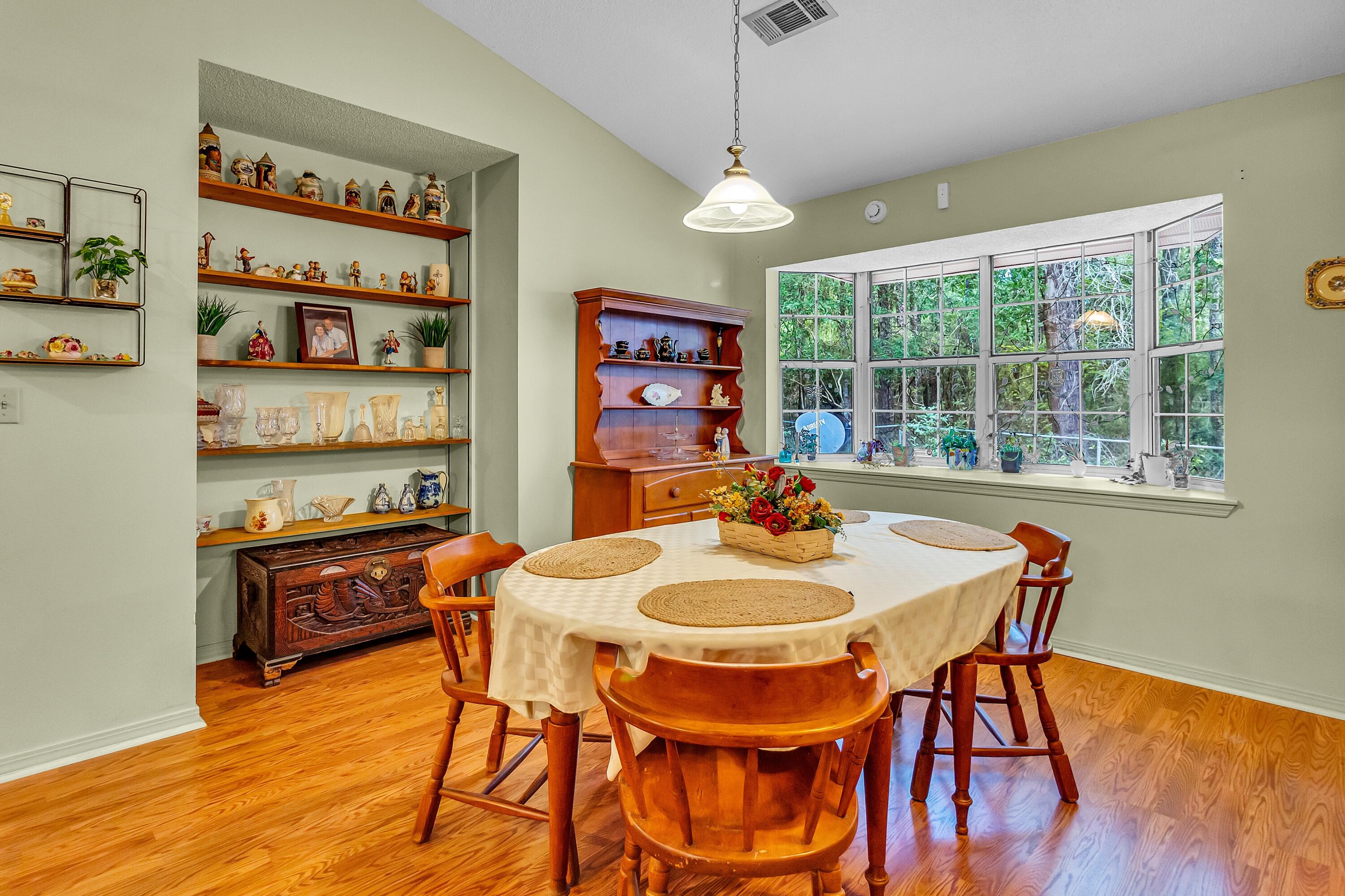 5957 Ridgecrest Road Crestview, FL 32539 - Photo 18 of 56 a view of a dining room with furniture window and wooden floor