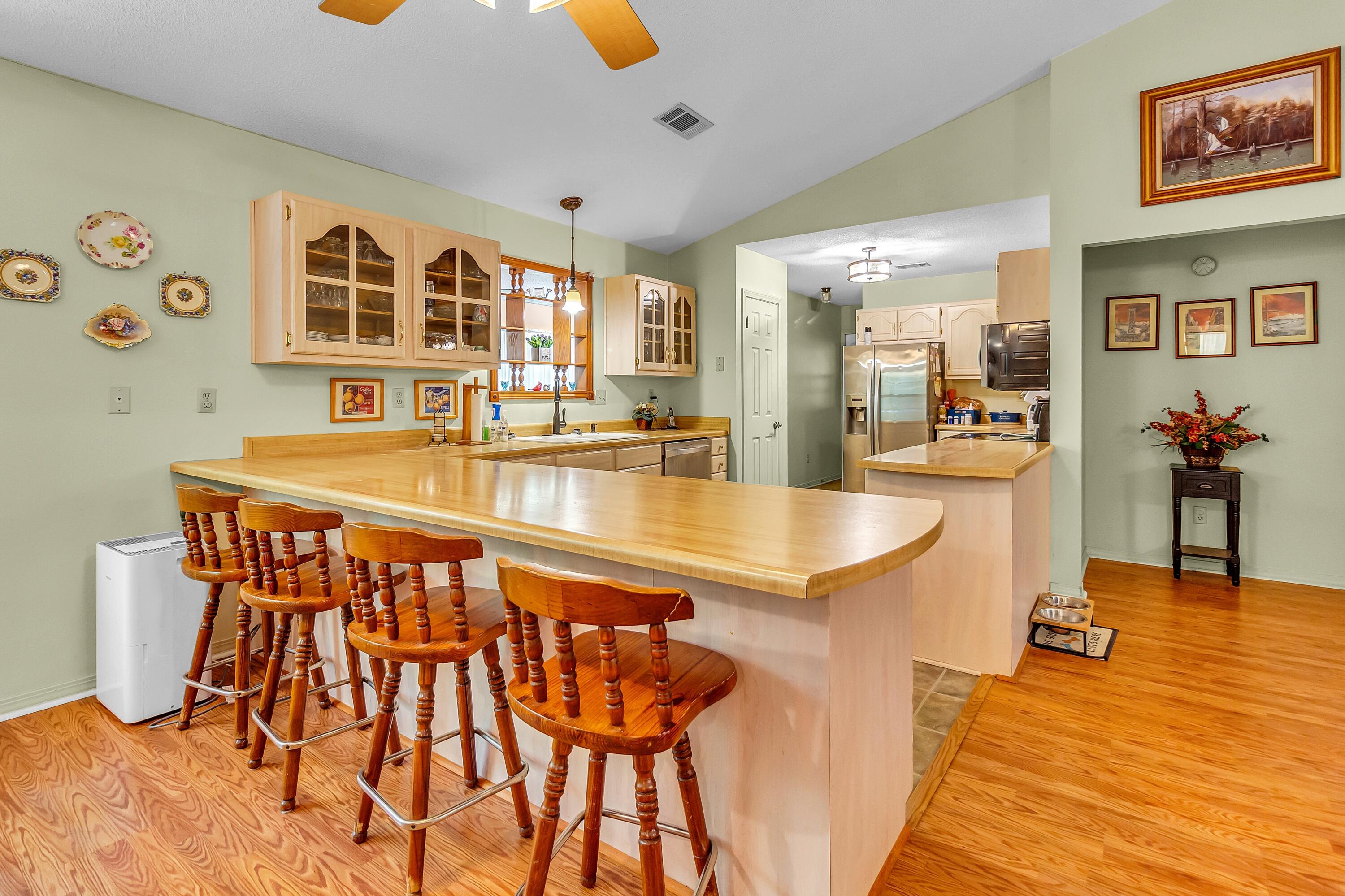 5957 Ridgecrest Road Crestview, FL 32539 - Photo 19 of 56 a dining hall with stainless steel appliances granite countertop a dining table and chairs with wooden floor