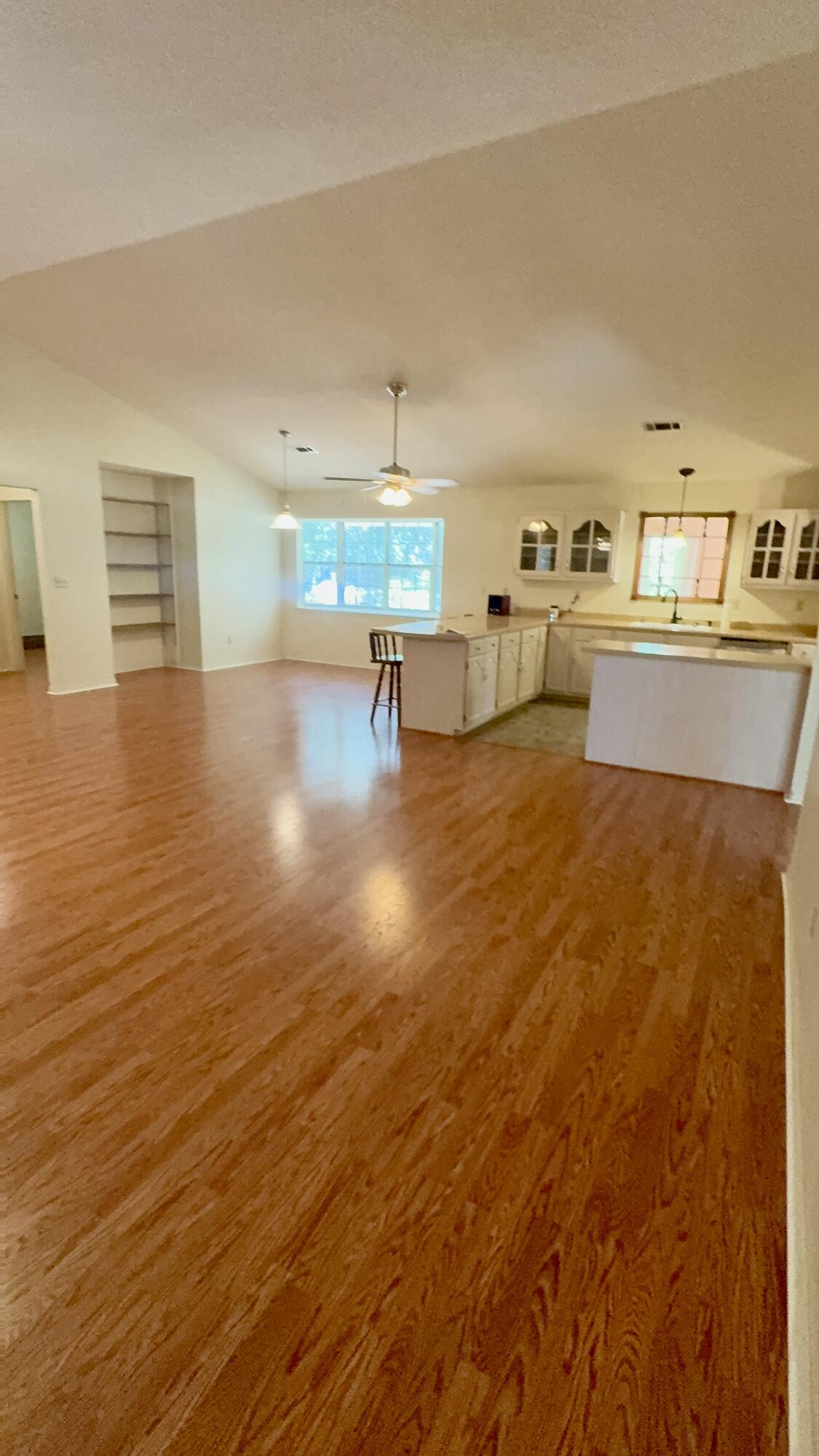 5957 Ridgecrest Road Crestview, FL 32539 - Photo 20 of 56 a view of a kitchen with kitchen island a sink wooden floor and a counter space