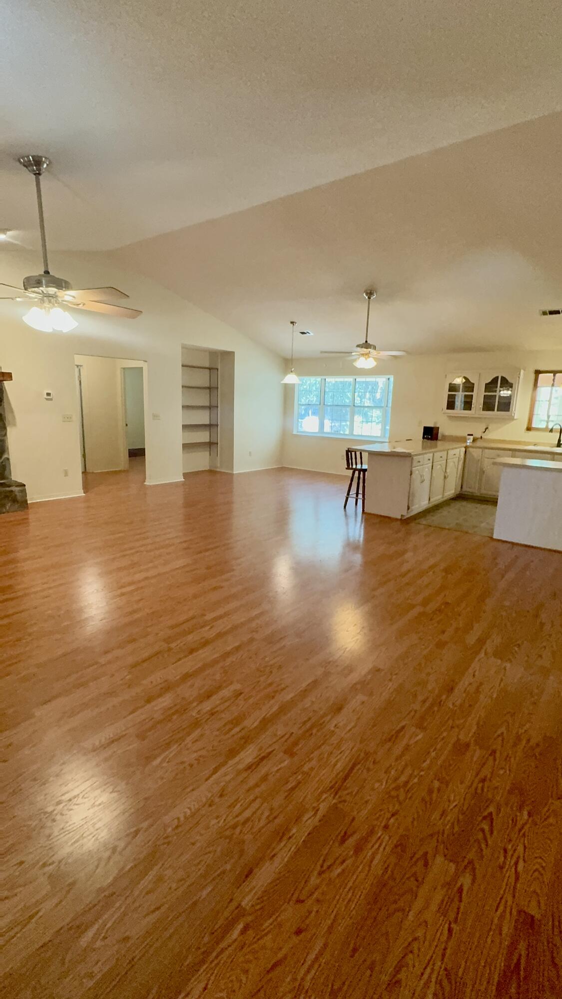 5957 Ridgecrest Road Crestview, FL 32539 - Photo 21 of 56 a view of a kitchen with kitchen island a sink wooden floor and counter space
