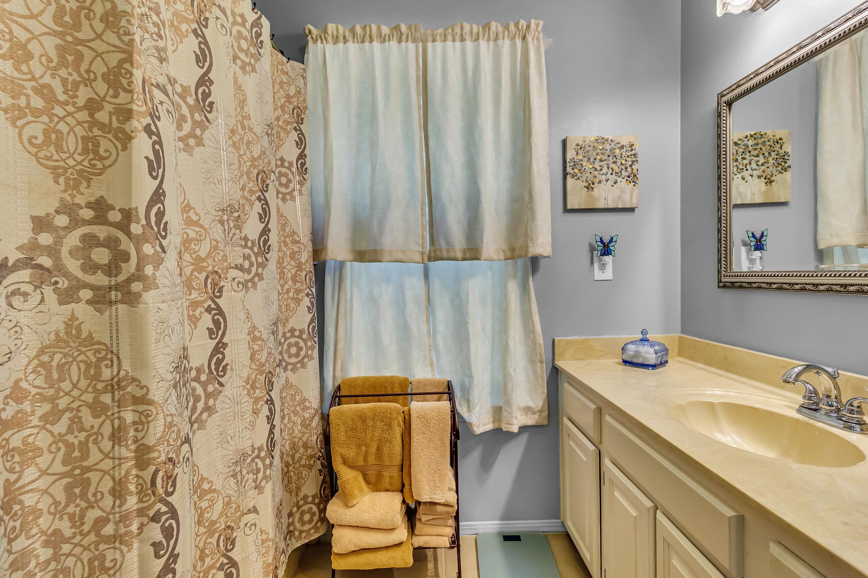 5957 Ridgecrest Road Crestview, FL 32539 - Photo 29 of 56 a bathroom with a sink and a mirror