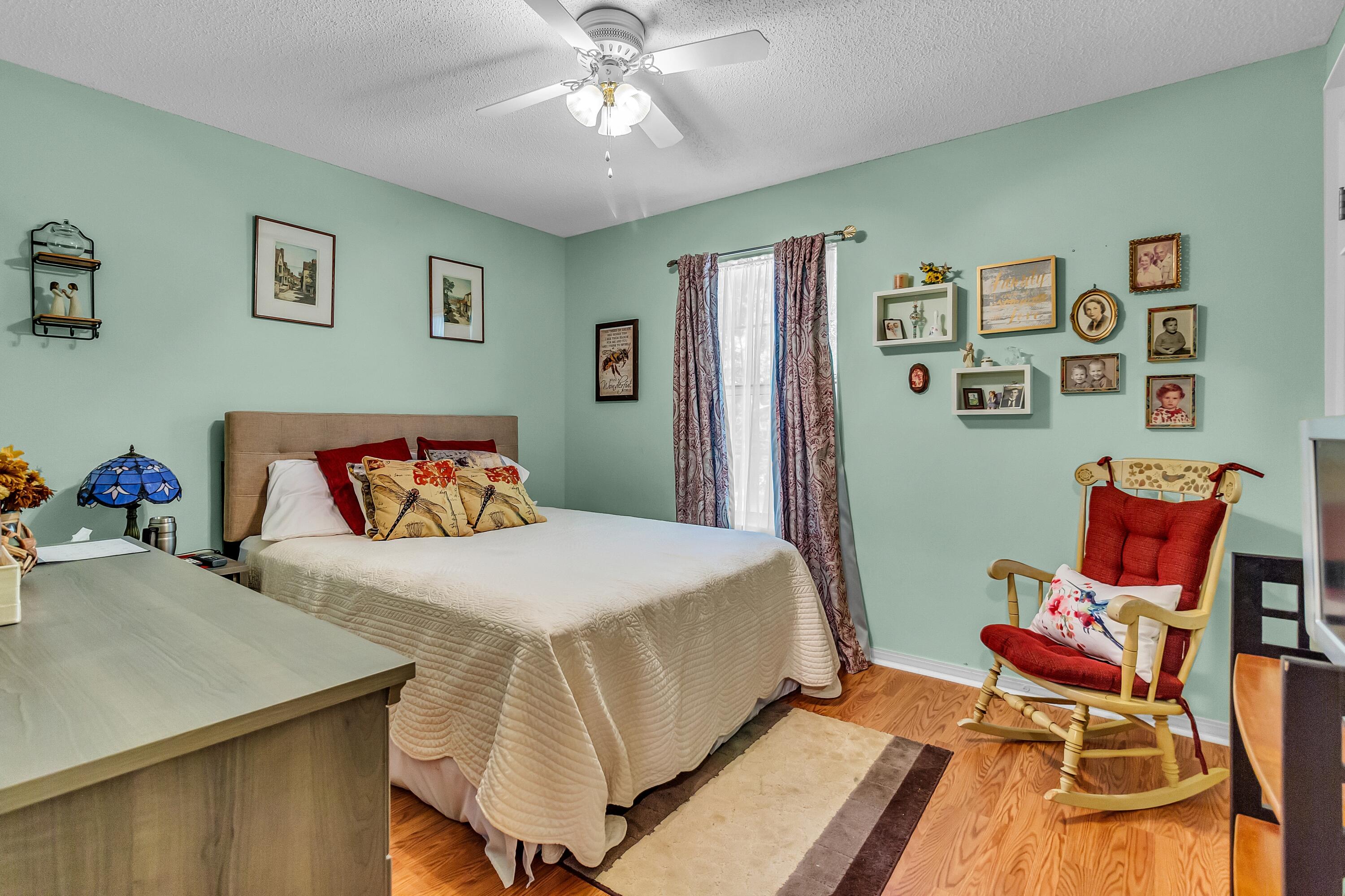 5957 Ridgecrest Road Crestview, FL 32539 - Photo 32 of 56 a bedroom with a bed and wooden floor