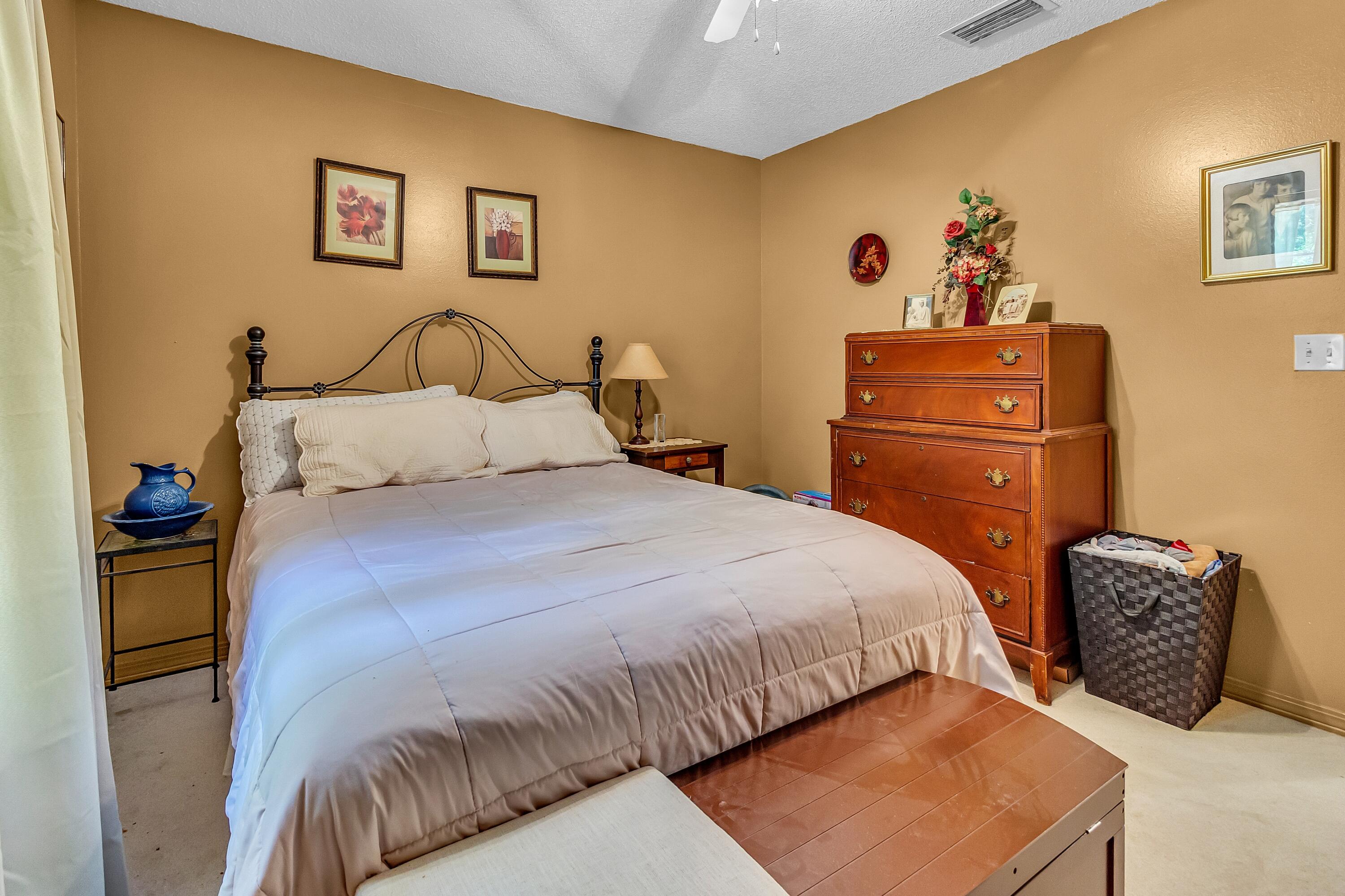 5957 Ridgecrest Road Crestview, FL 32539 - Photo 35 of 56 a bedroom with two beds and a painting on the wall