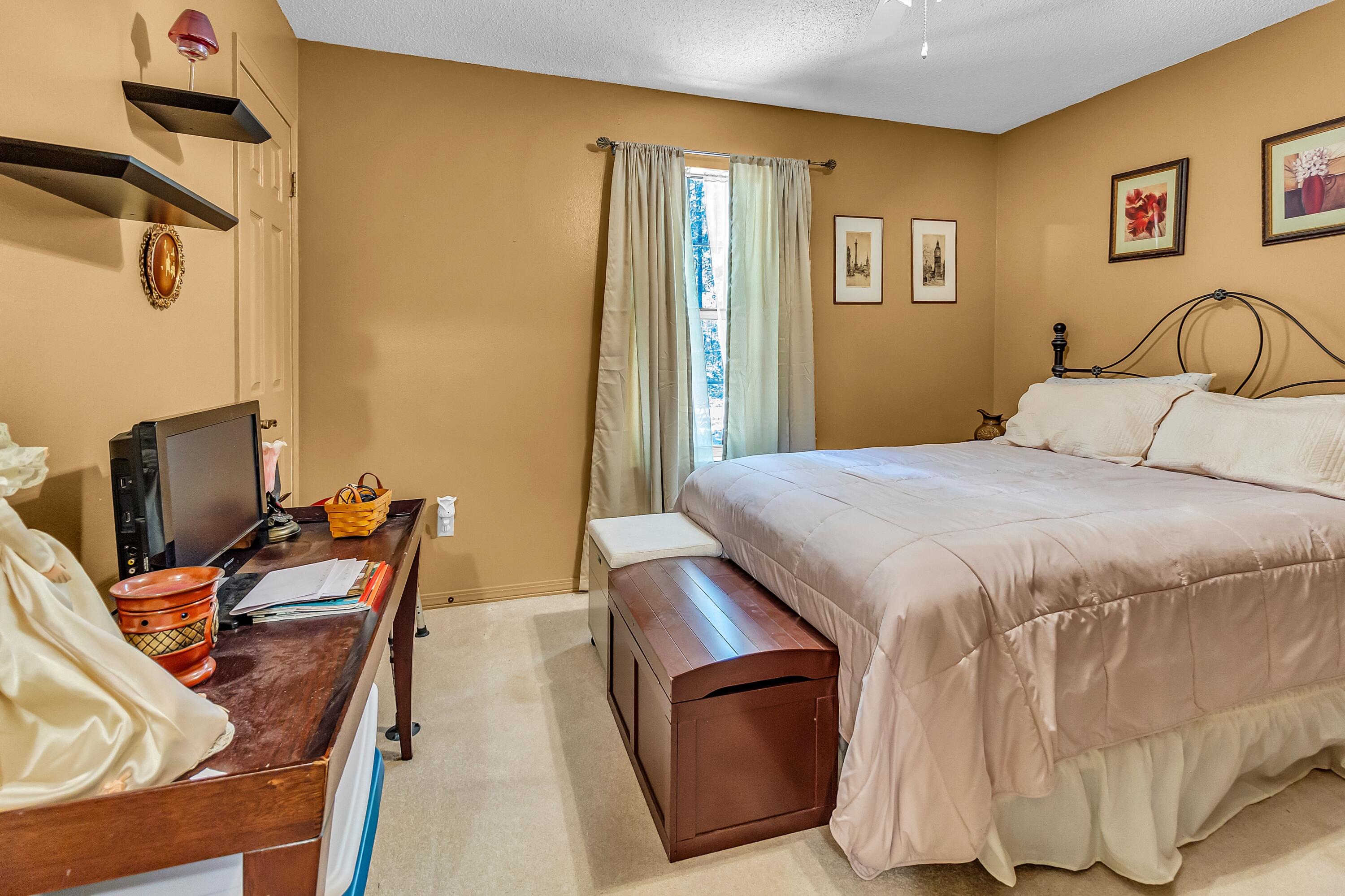 5957 Ridgecrest Road Crestview, FL 32539 - Photo 36 of 56 a bedroom with a bed and a desk