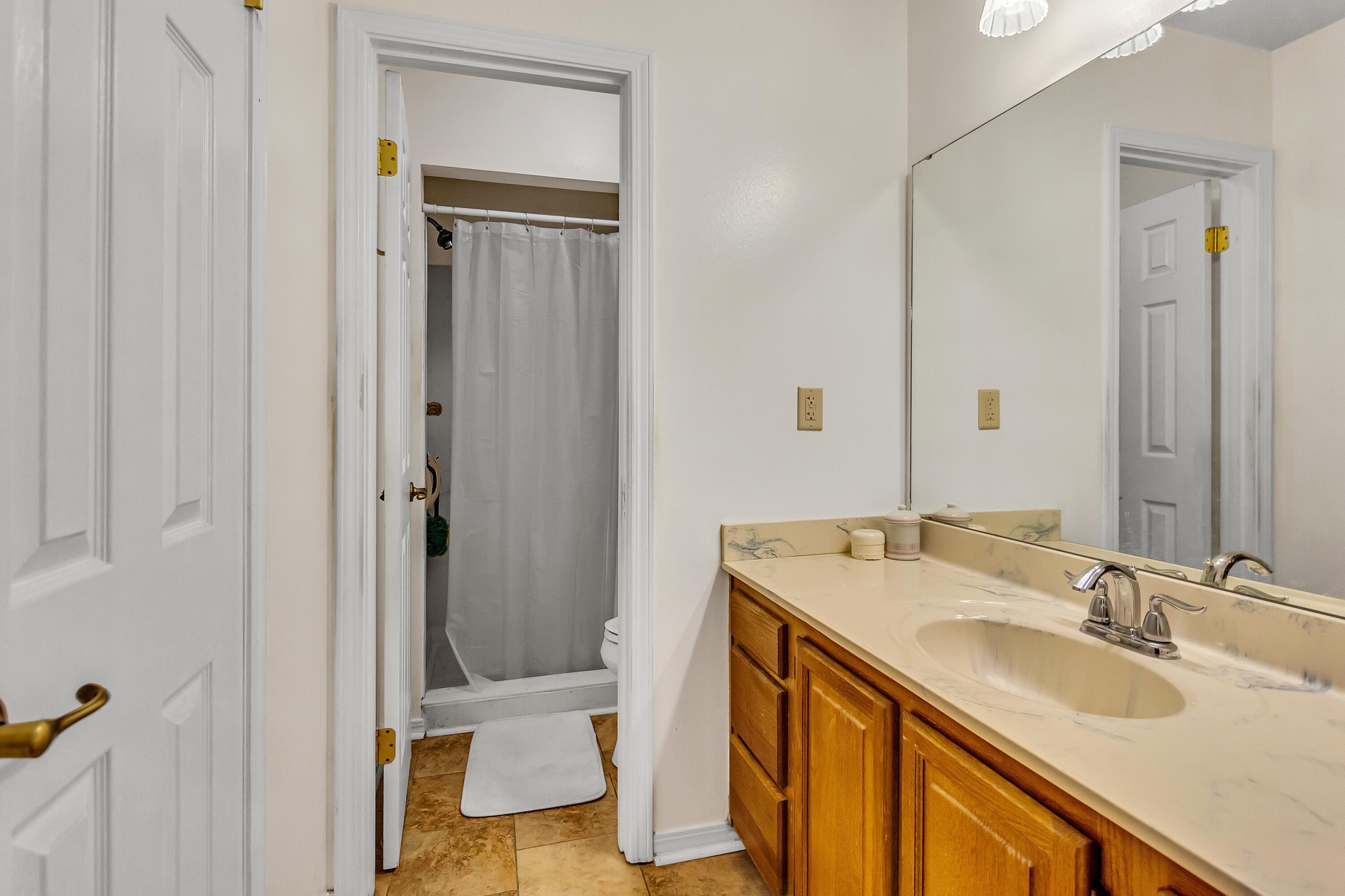 5957 Ridgecrest Road Crestview, FL 32539 - Photo 43 of 56 a bathroom with a sink a vanity and a mirror