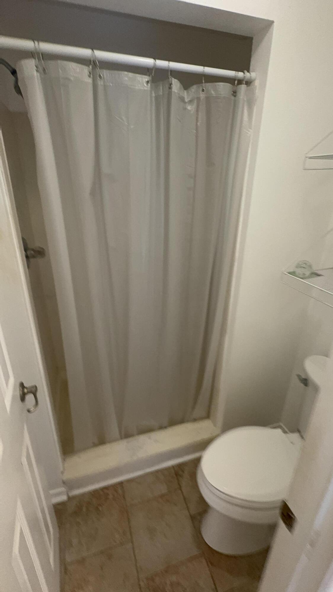 5957 Ridgecrest Road Crestview, FL 32539 - Photo 44 of 56 a white toilet sitting next to a shower curtain