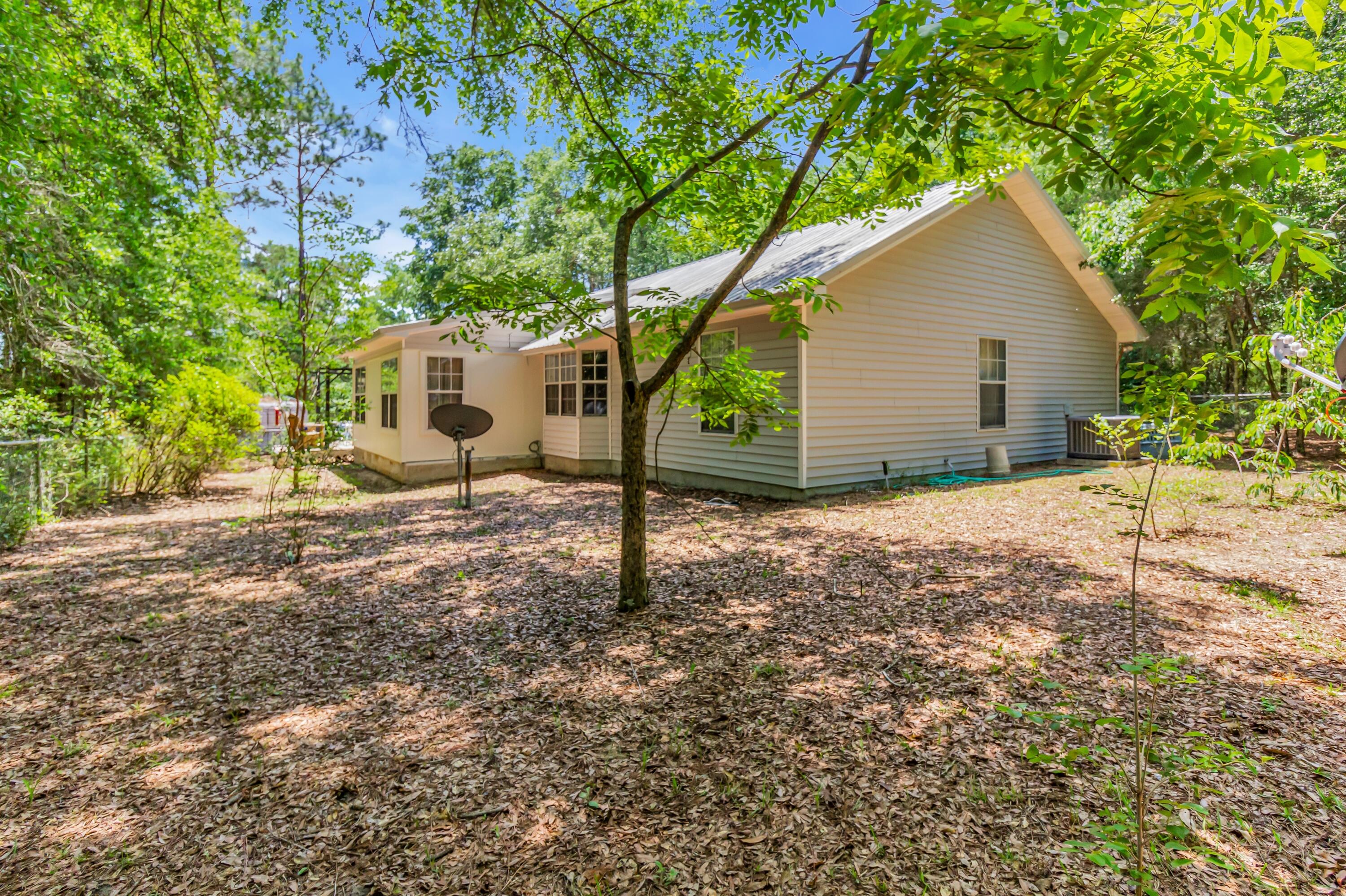 5957 Ridgecrest Road Crestview, FL 32539 - Photo 46 of 56 a backyard of a house with table and chairs