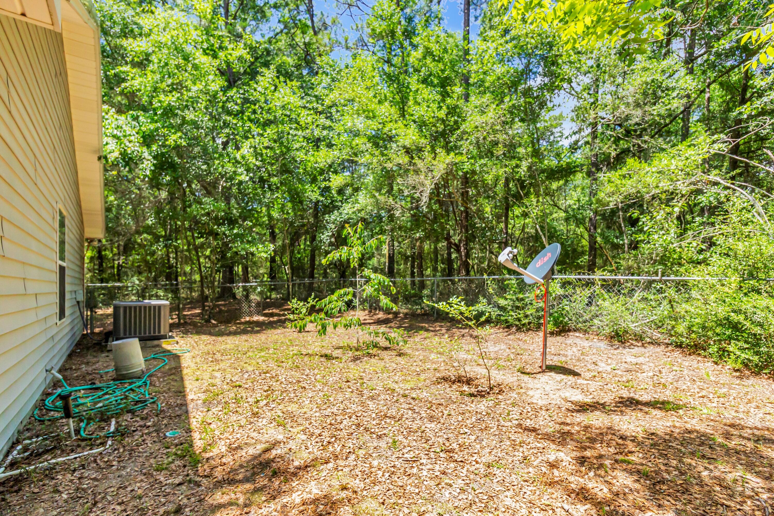 5957 Ridgecrest Road Crestview, FL 32539 - Photo 47 of 56 a backyard of a house with a tree