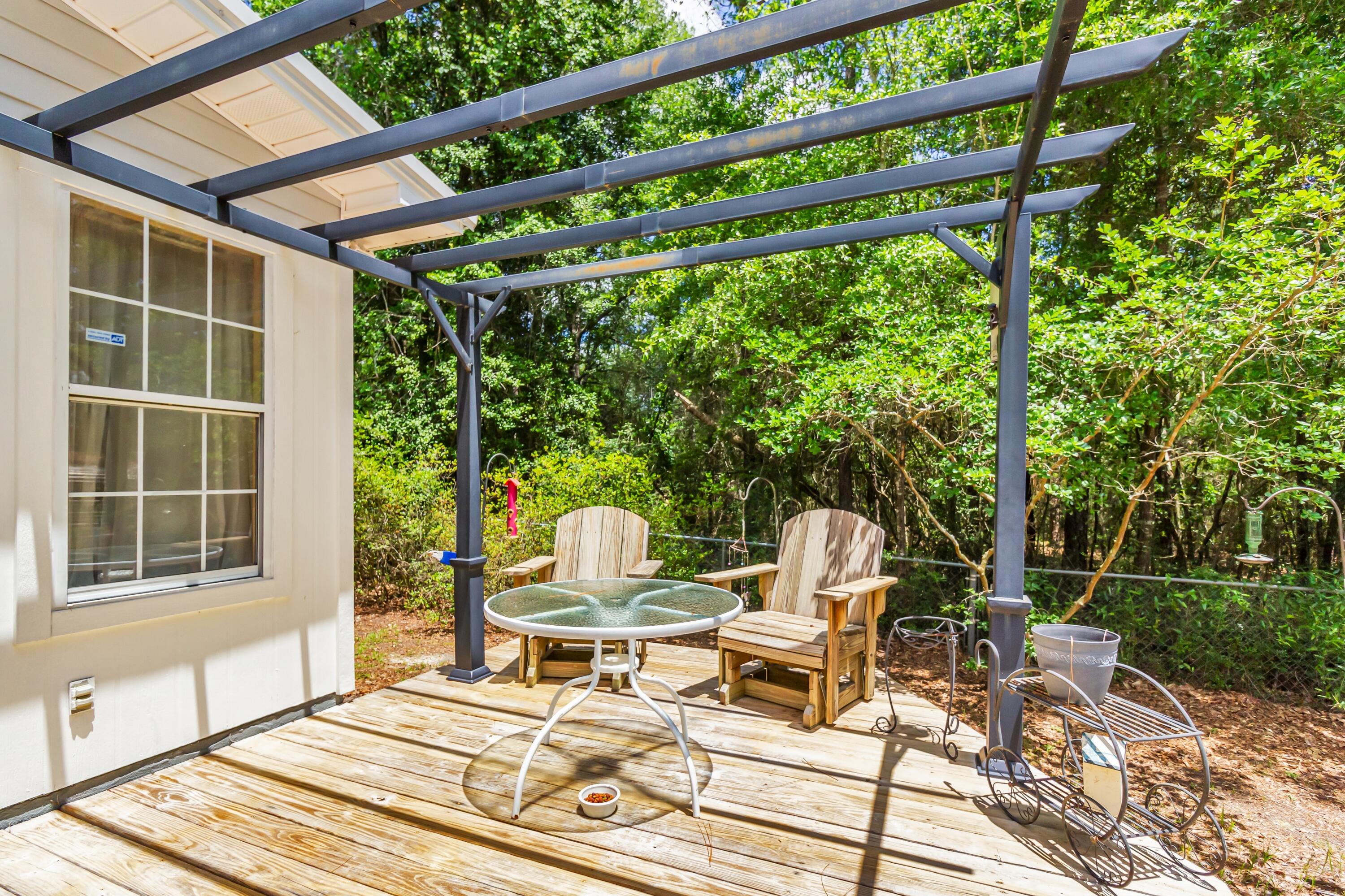 5957 Ridgecrest Road Crestview, FL 32539 - Photo 50 of 56 a chair and table sitting in backyard of a house