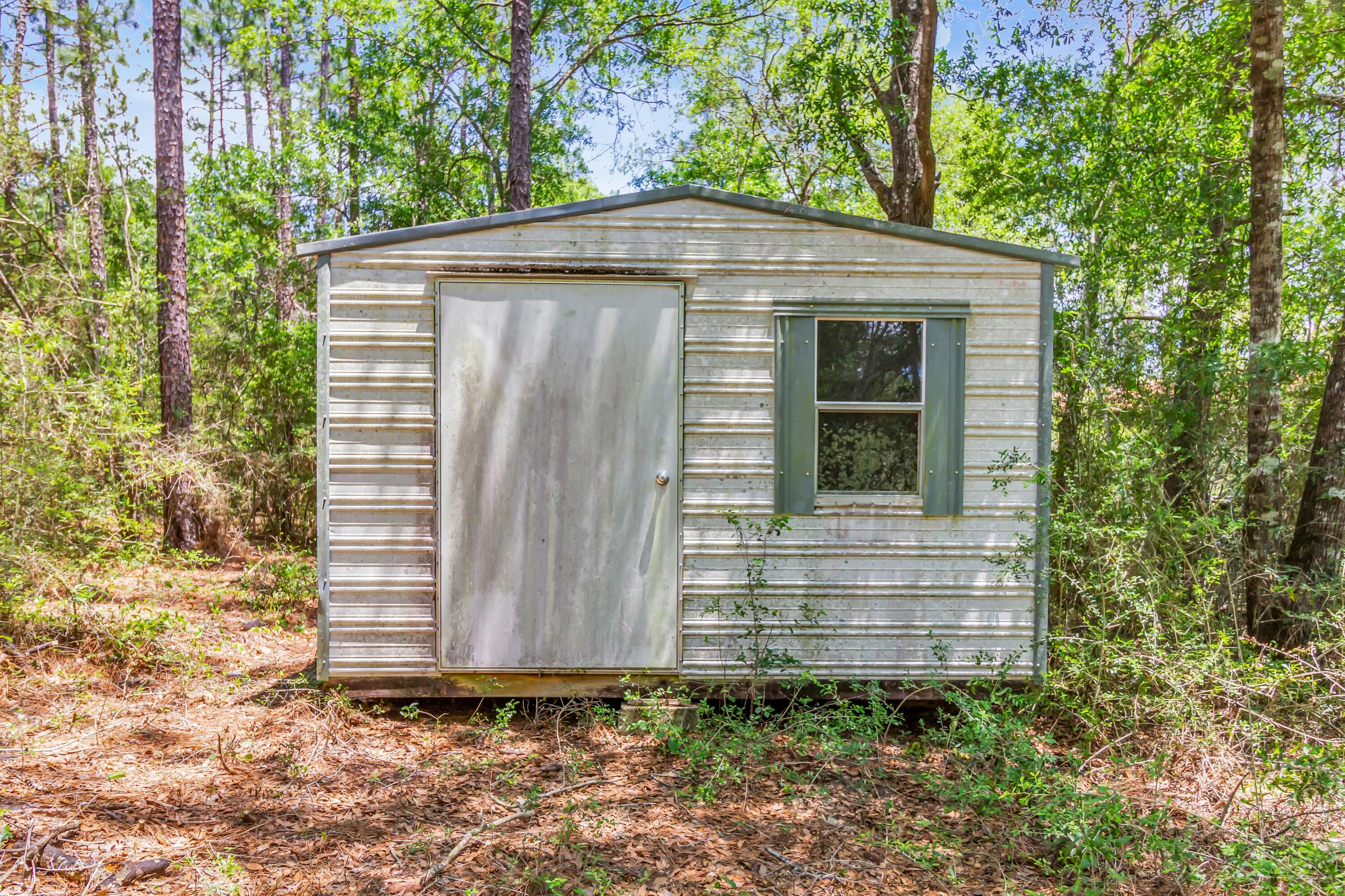 5957 Ridgecrest Road Crestview, FL 32539 - Photo 54 of 56 a backyard of a house with lots of green space