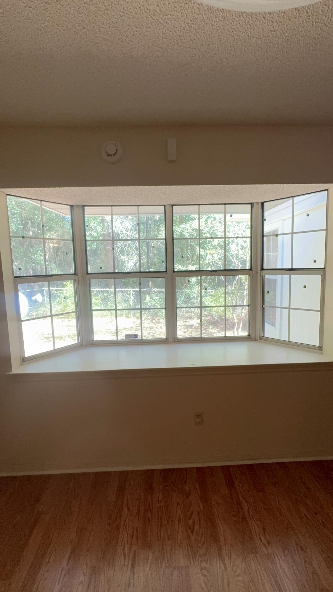 5957 Ridgecrest Road Crestview, FL 32539 - Photo 7 of 56 an empty room with wooden floor and windows