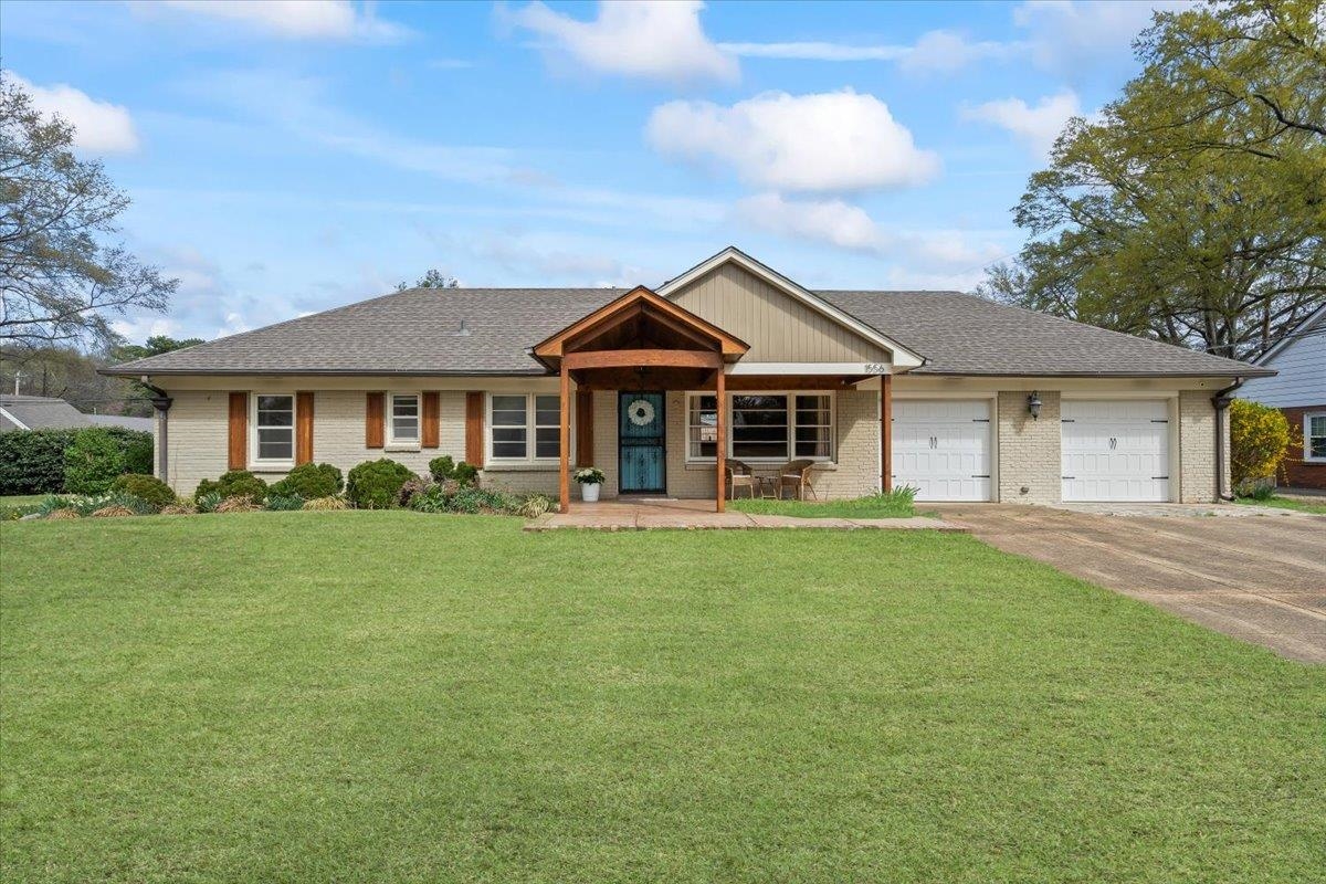 1556 Hayne Road Memphis, TN 38119 - Photo 1 of 27 a front view of a house with a garden