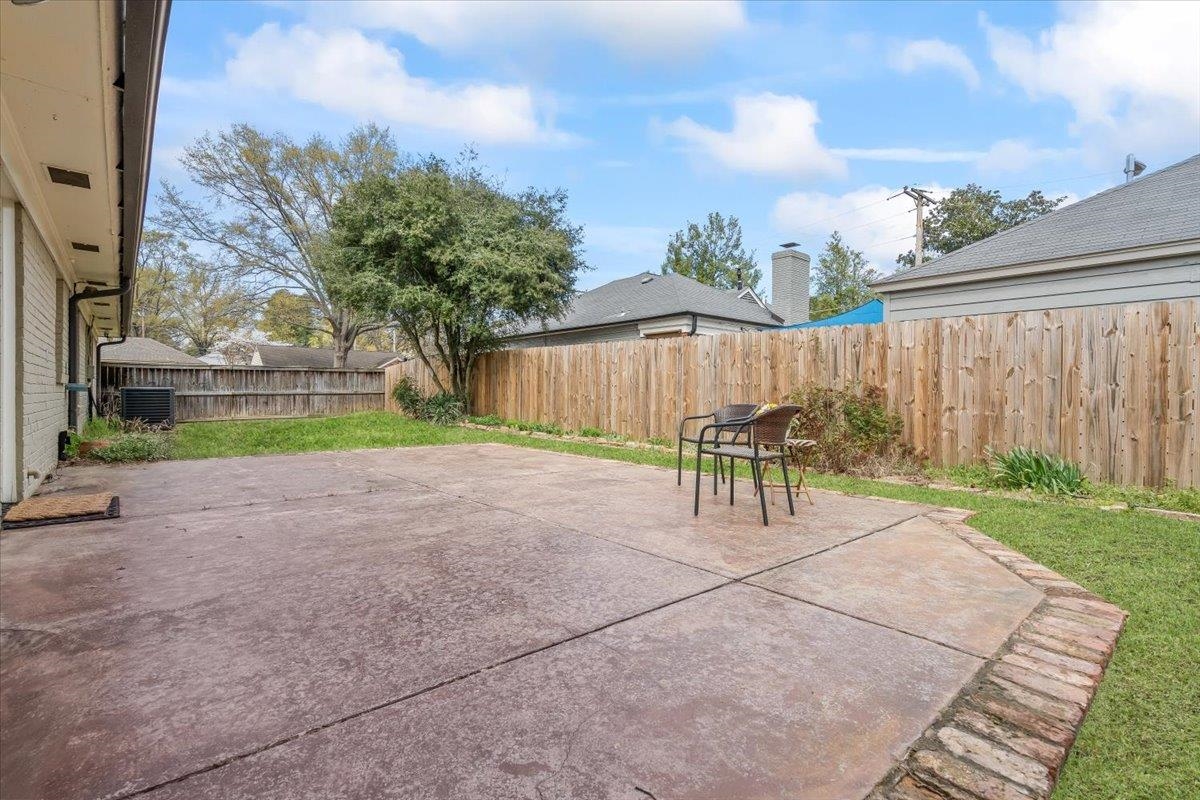 1556 Hayne Road Memphis, TN 38119 - Photo 20 of 27 a view of backyard with table and chairs and wooden fence