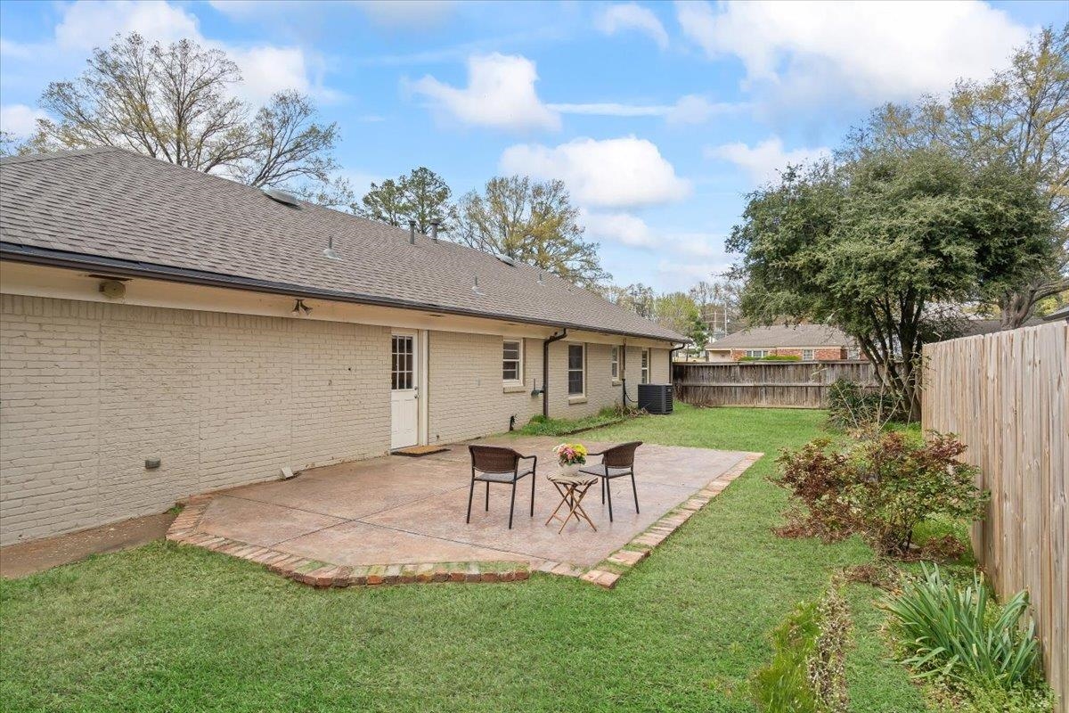 1556 Hayne Road Memphis, TN 38119 - Photo 23 of 27 a white house with a table and chairs in patio