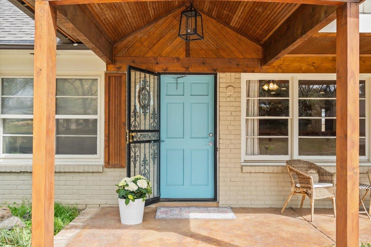 1556 Hayne Road Memphis, TN 38119 - Photo 3 of 27 a front view of a house with a window and a potted plant