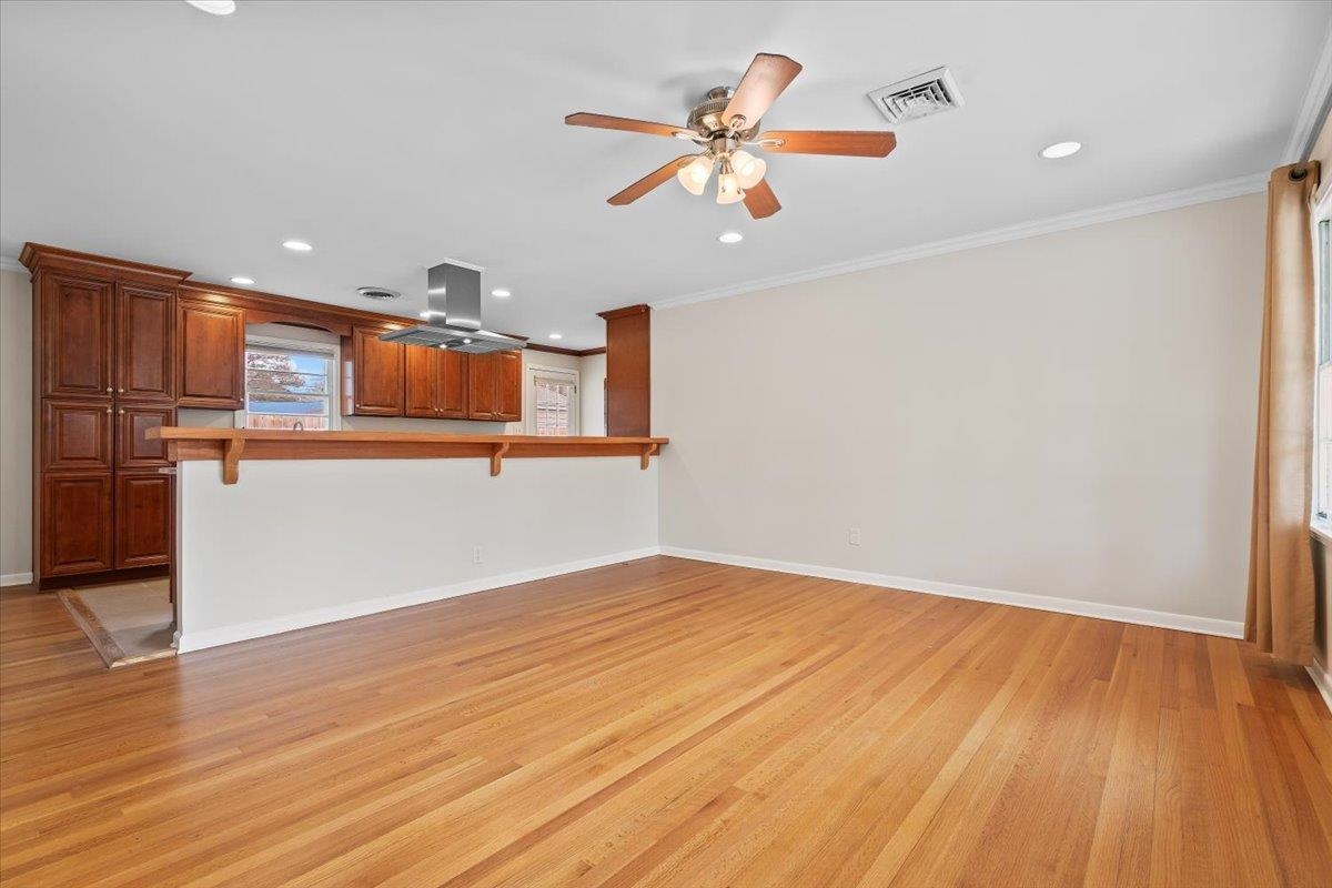 1556 Hayne Road Memphis, TN 38119 - Photo 4 of 27 wooden floor in an empty room with a window